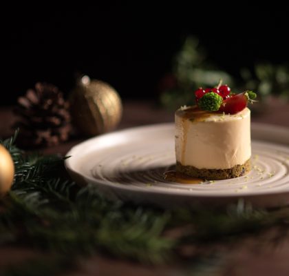 A plate of a  fruitcake with strawberry and cranberries.