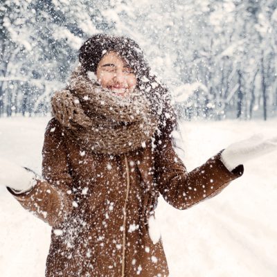 Winter Mood. Excited Girl Throwing Snow Having Fun Walking In Snowy Forest In The Morning.